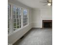Living room with fireplace and large windows offering natural light at 113 Crosswind Dr, Cary, NC 27513