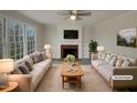 Virtually staged living room featuring fireplace and ample natural light at 113 Crosswind Dr, Cary, NC 27513
