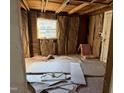 Under construction bedroom with exposed walls and window at 203 Hope St, Erwin, NC 28339