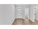 Light and bright entryway with wood-look flooring and white doors at 208 Brickwell Way, Youngsville, NC 27596