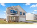 Two-story house with gray siding, stone accents, and a two-car garage at 208 Leven Dr, Gibsonville, NC 27249