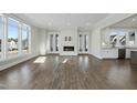 Bright living room with hardwood floors and a modern fireplace at 235 Cottage Way, Pittsboro, NC 27312
