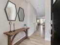 Bright entryway with wood console table, mirrors, and hardwood floors at 259 Whitley Ridge Dr, Clayton, NC 27527