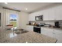 Island kitchen with granite countertops and stainless steel appliances at 103 Reagan Crest Dr, Clayton, NC 27520