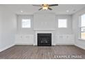 Living room with hardwood floors, fireplace, and large windows at 409 Reinsman Ct, Mebane, NC 27302