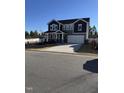 Two-story home with gray siding, stone accents, and a two-car garage at 490 Mallard Loop Dr, Clayton, NC 27527