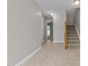 Hallway view with staircase, access to other rooms and tiled floor at 5147 Sandy Banks Rd, Raleigh, NC 27616