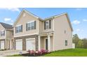 Two-story townhome with stone accents and landscaping at 5512 Henley Ridge Dr # 191, Graham, NC 27253