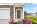 Townhome's front door with stone and landscaping at 5512 Henley Ridge Dr # 191, Graham, NC 27253