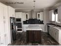 Modern kitchen with white cabinets, an island, and stainless steel appliances at 6016 Charlies Deadend Rd, Efland, NC 27243