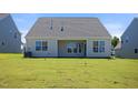 Newly built home with a large grassy backyard and covered patio at 1129 Capulet Dr, Burlington, NC 27215