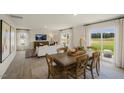Open dining room with wood table and access to the kitchen and patio at 113 Reagan Crest Dr, Clayton, NC 27520