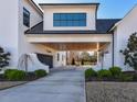 Covered parking area with two garage doors and beautiful landscaping at 1425 Sky Vista Way, Raleigh, NC 27613