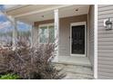 Front entrance with black door, stone steps, and porch at 188 Avery Meadows Dr, Smithfield, NC 27577