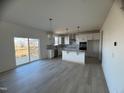 Modern kitchen with white cabinets, island, and sliding glass door to deck at 321 Spelt Ct, Rolesville, NC 27571