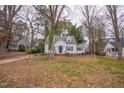 White house with mature trees and landscaping at 421 S Morgan St, Roxboro, NC 27573