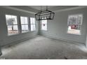 Bright breakfast nook with three windows and a modern chandelier at 5168 Church Rd # 22, New Hill, NC 27562