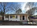 Updated ranch home features a charming front porch and brick facade at 603 Forest Dr, Garner, NC 27529