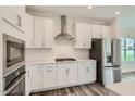 Modern kitchen with white cabinets, stainless steel appliances, and white subway tile backsplash at 604 Emerald Bay Cir, Raleigh, NC 27610