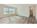 Bright and airy living room with hardwood floors and large windows at 604 Emerald Bay Cir, Raleigh, NC 27610