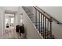Elegant staircase with black spindles and wood handrail at 605 Emerald Bay Cir, Raleigh, NC 27610