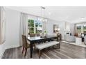 Modern dining room with hardwood floors and large windows at 609 Emerald Bay Cir, Raleigh, NC 27610