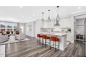 Open concept kitchen with white cabinets, island, and stainless steel appliances at 609 Emerald Bay Cir, Raleigh, NC 27610