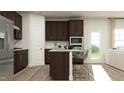 Modern kitchen with dark brown cabinets, granite countertops, and island at 612 Emerald Bay Cir, Raleigh, NC 27610