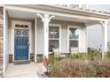 Inviting front porch with blue door and comfortable seating at 79 Stallion Way, Benson, NC 27504