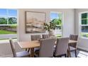 Elegant dining area with a wood table and six chairs at 825 Windmill Palm Dr, Zebulon, NC 27597