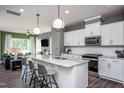 Open concept kitchen with stainless steel appliances and an island with seating at 391 Fosterton Cottage Way, Raleigh, NC 27603