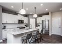 Modern kitchen with white cabinets, granite countertops, and a large island at 391 Fosterton Cottage Way, Raleigh, NC 27603
