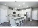 Modern kitchen with white cabinets, quartz countertops, and stainless steel appliances at 393 Fosterton Cottage Way, Raleigh, NC 27603