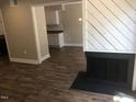 Open living area with wood-look floors and view into kitchen at 4600 Millstone Dr # D, Raleigh, NC 27604