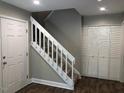 Stairwell with white railing and storage at 4600 Millstone Dr # D, Raleigh, NC 27604