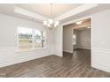 Bright dining room with hardwood floors and wainscoting at 590 Glenkirk Pl, Garner, NC 27529