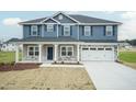 Two-story house with blue siding, stone accents, and a two-car garage at 590 Glenkirk Pl, Garner, NC 27529