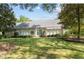 Ranch style home with a landscaped yard at 7201 North Ridge Dr, Raleigh, NC 27615