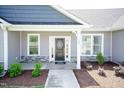 Two-story home exterior with gray siding, stone accents, and a covered front porch at 104 Newport Landing Lndg # 100, Garner, NC 27529