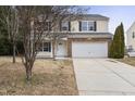 Two-story house with stone accents and a large driveway at 1204 Chamberwell Ave, Wake Forest, NC 27587