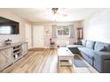 Living room with sectional sofa, TV, and wood-look floors at 130 S Estes Dr # A8, Chapel Hill, NC 27514