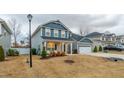 Two-story home with gray and blue siding, front porch, and landscaped yard at 182 Hillmont Dr, Garner, NC 27529