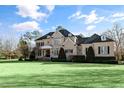 Brick house with a large front yard, landscaping and a three-car garage at 193 N Grande Overlook Dr, Clayton, NC 27527