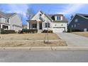 Beautiful white two-story house with landscaping and a paved driveway at 2317 Glade Mill Ct, Fuquay Varina, NC 27526