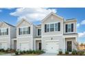 Two story townhome with gray siding, two car garage, and landscaping at 232 Starlight St, Sanford, NC 27330