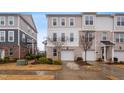 Two-story townhome with brick and siding exterior, two-car garage, and landscaped front yard at 360 Skymont Dr, Holly Springs, NC 27540