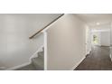 A light and bright entryway with carpeted stairs and wood-look flooring at 506 Fife Ct, Gibsonville, NC 27249