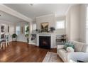 Living room with fireplace, built-in shelving, hardwood floors and comfy seating at 6604 Truxton Ln, Raleigh, NC 27616