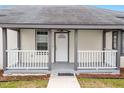 Inviting front porch with gray railings and a white door at 115 Kerr Dr, Roxboro, NC 27573