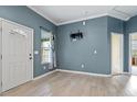 Light and airy living room with gray walls, wood-look flooring, and a view of the backyard at 115 Kerr Dr, Roxboro, NC 27573